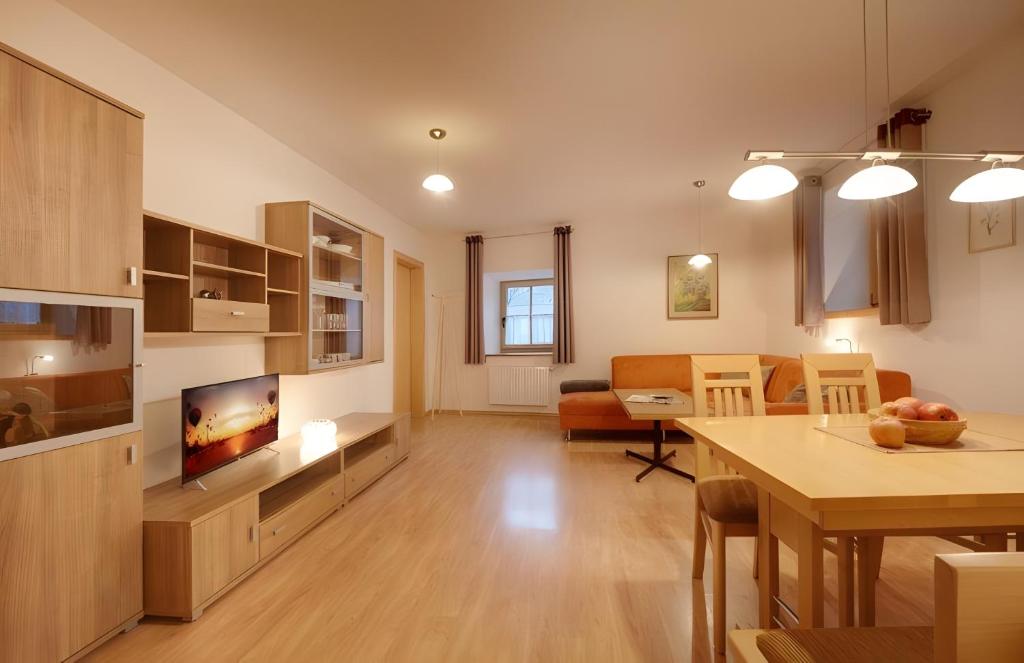 a living room with a kitchen and a dining room at Rafaser - Apartment Albina in Feldthurns