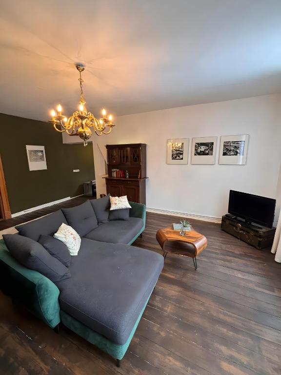 a living room with a couch and a table at Gutsherren Räume in Groß Upahl
