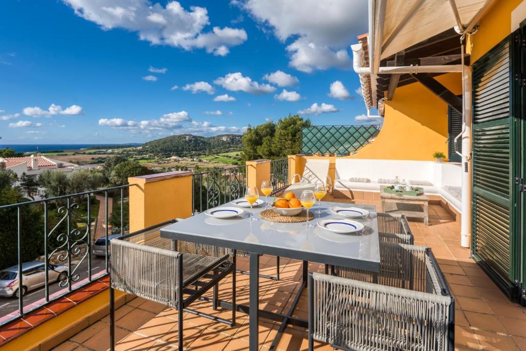 a patio with a table and chairs on a balcony at Petit Paradis Apartment in Son Bou