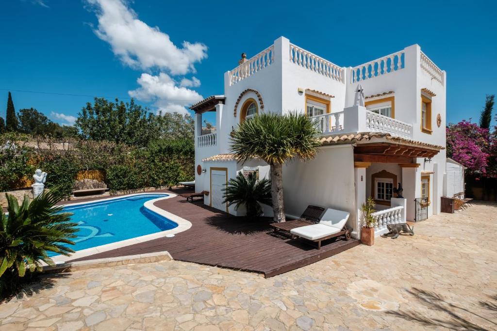 a villa with a swimming pool and a house at Villa Alba in Santa Eularia des Riu
