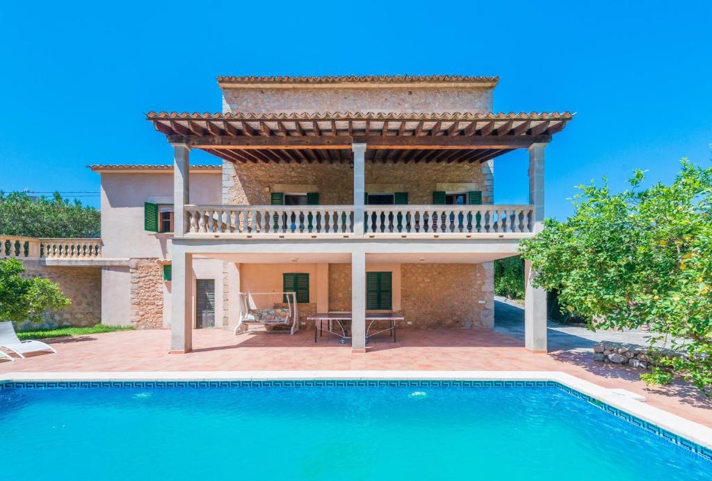 a villa with a swimming pool and a house at Can Guixa in Sóller