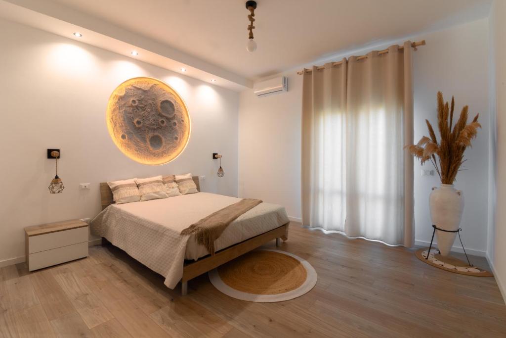 a bedroom with a bed and a large window at La Dimora di Luna in Terrasini