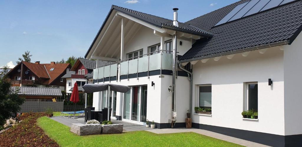 a white house with a black roof at Ferienhaus Am Rösslewald in Breitnau
