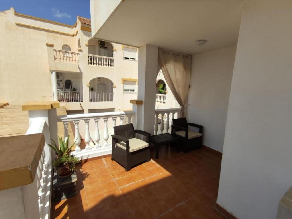 a balcony of a building with two chairs at Cerca plaza de Toros Vera in Vera