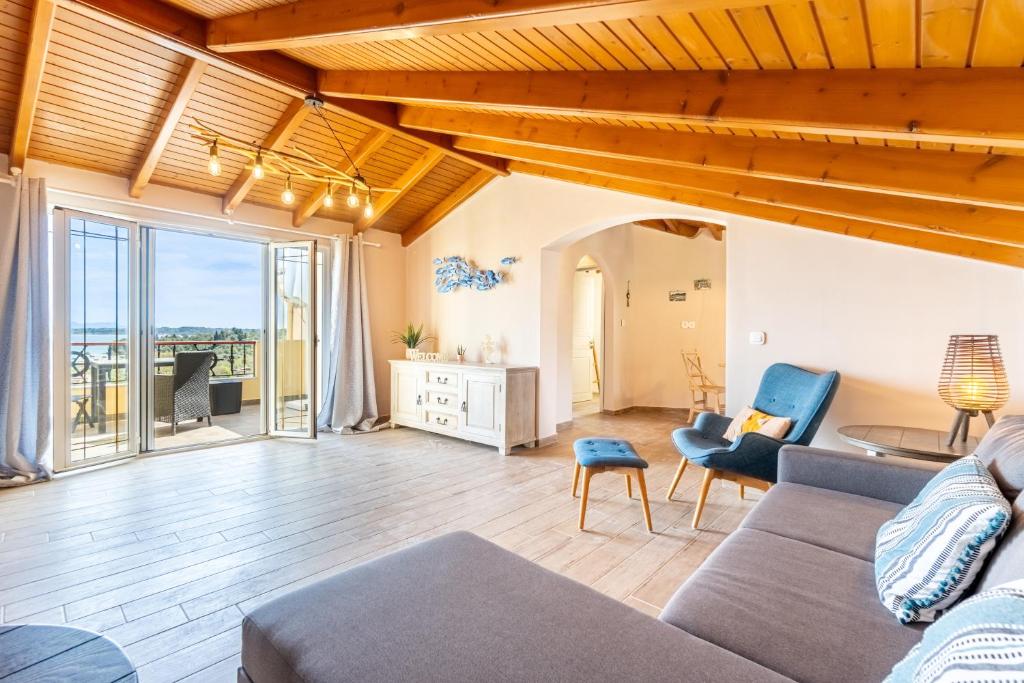 a living room with a couch and a table at Villa Konstantina Lulas Penthouse in Petrití