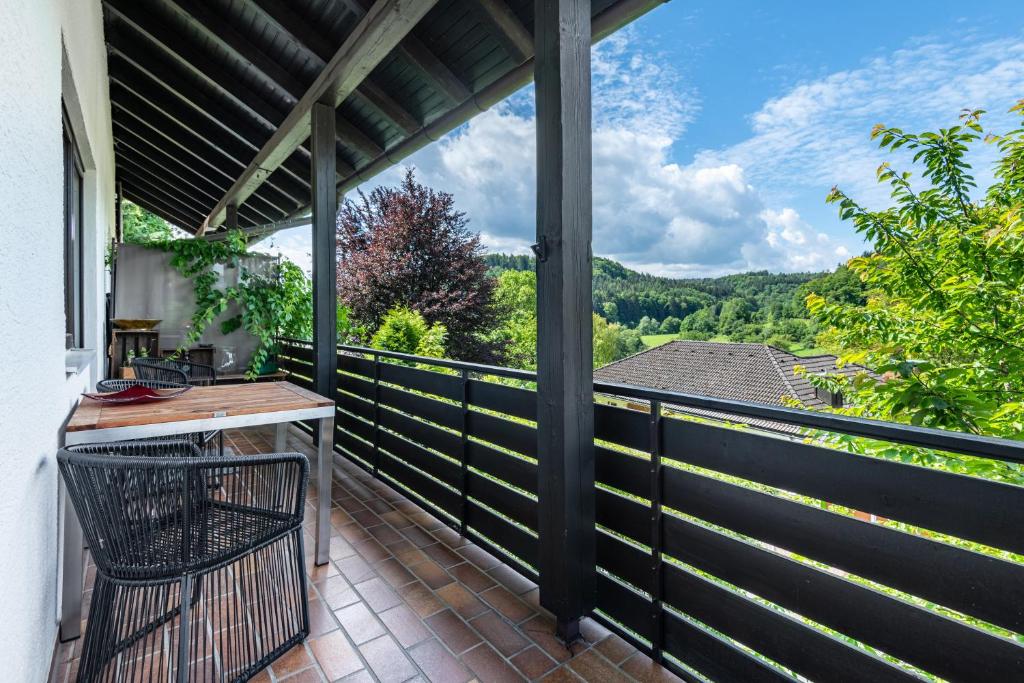 a screened in porch with a view of the mountains at Schlossblick in Egloffstein