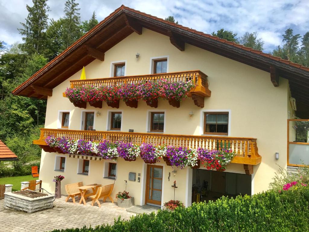 a house with flowers on the balcony at Haus Peschl Fewo 2 in Neureichenau