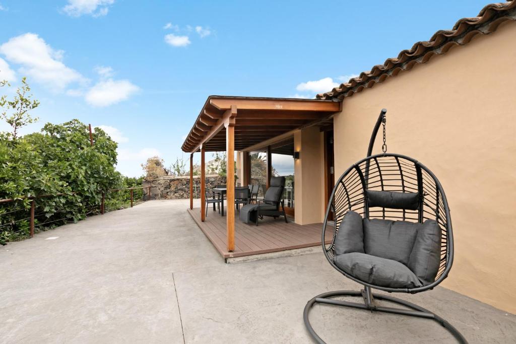 a rattan chair sitting on a patio at El Portillo 2 in Buenavista del Norte