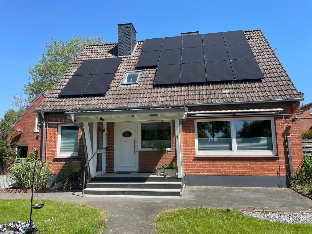 a house with solar panels on the roof at Ferienwohnung Moin in Schönwalde am Bungsberg