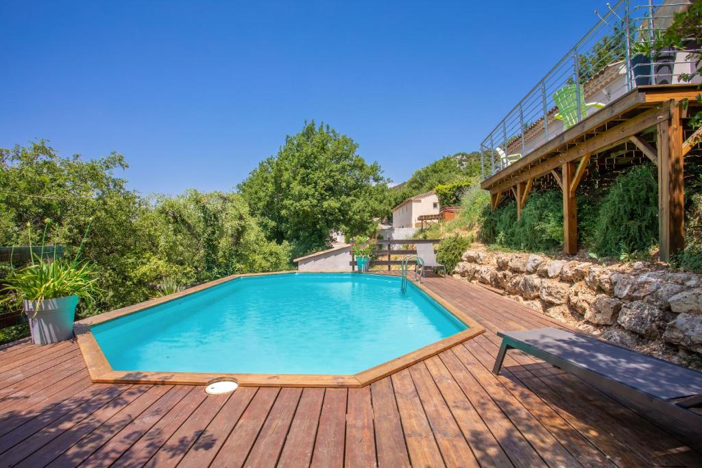 a swimming pool on a wooden deck at Villa Les Brés in Bauduen