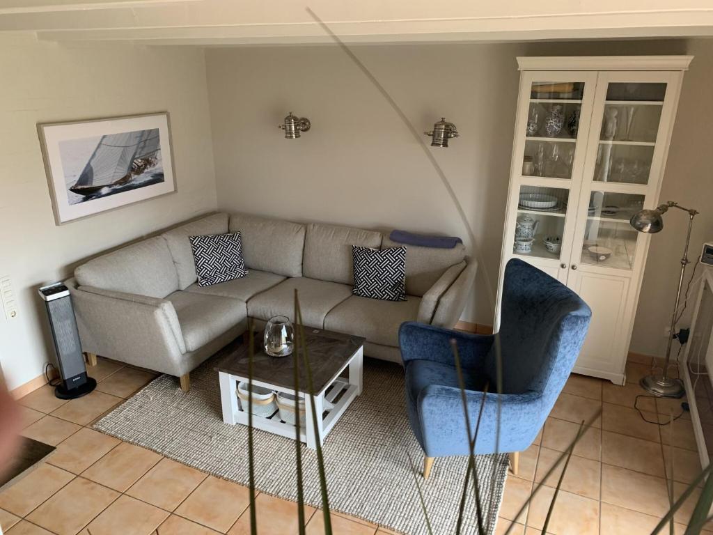 a living room with a couch and a table at Meerchenhaus in Wenningstedt