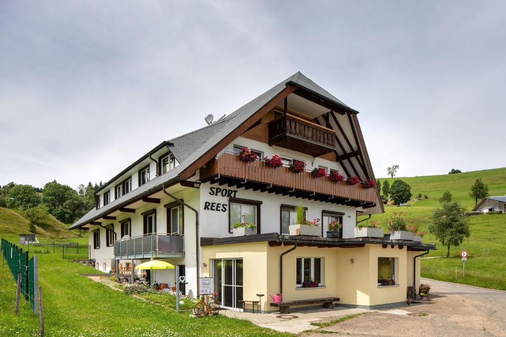 a large white building with a porch and balcony at Sport Rees - Ferienwohnung Melanie in Oberried