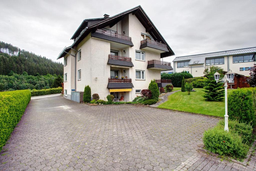 a large white building with a pitched roof at Haus Zur Laterne in Willingen