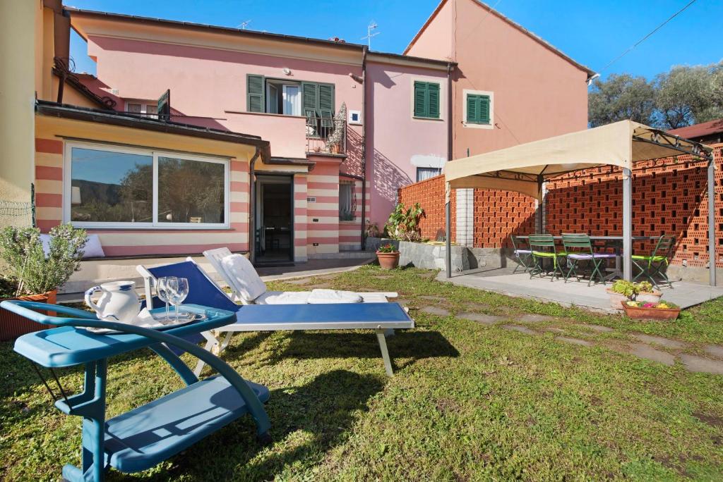 a backyard with a blue chaise lounge and a house at Nonna Adele in Sestri Levante