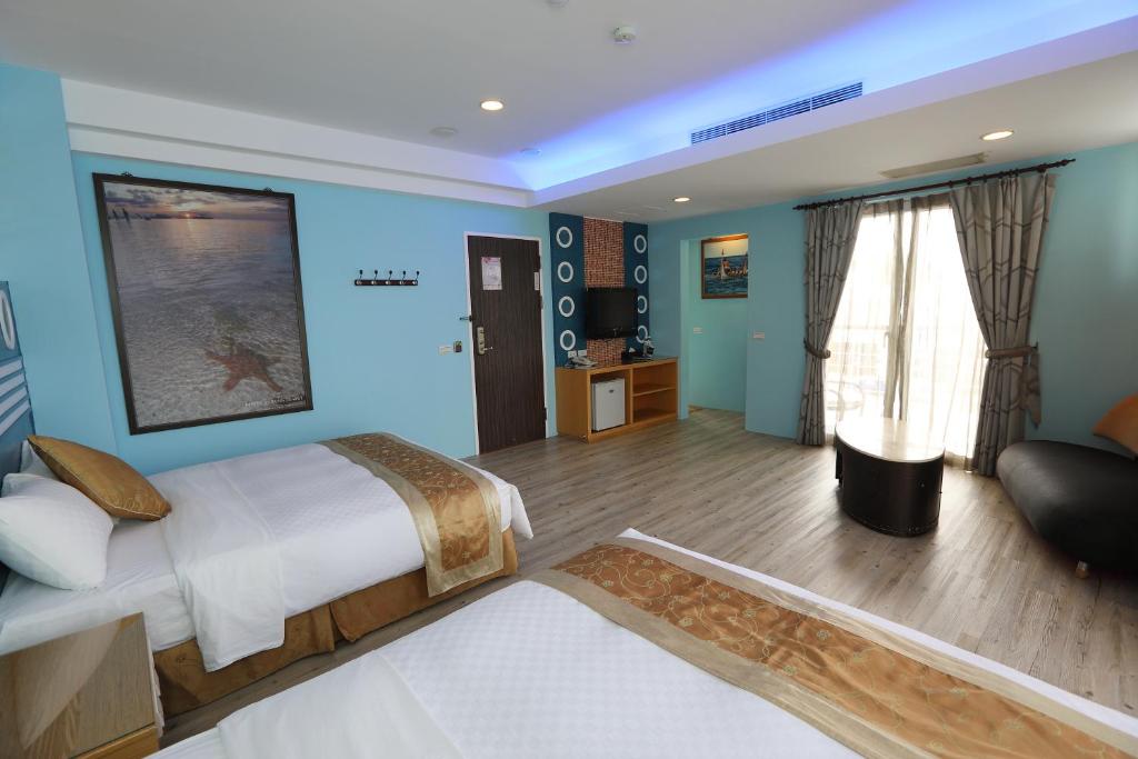 a bedroom with a large bed and a living room at Hang Hai B&amp;B in Eluan