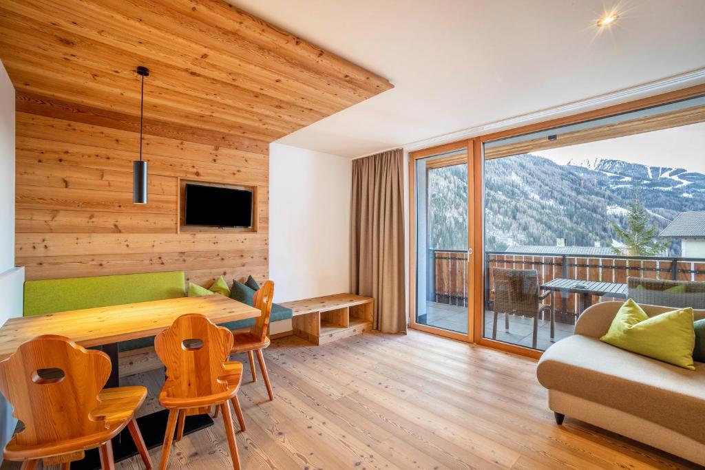 a living room with a table and a couch at Stoana Apt 4-2 in San Giacomo