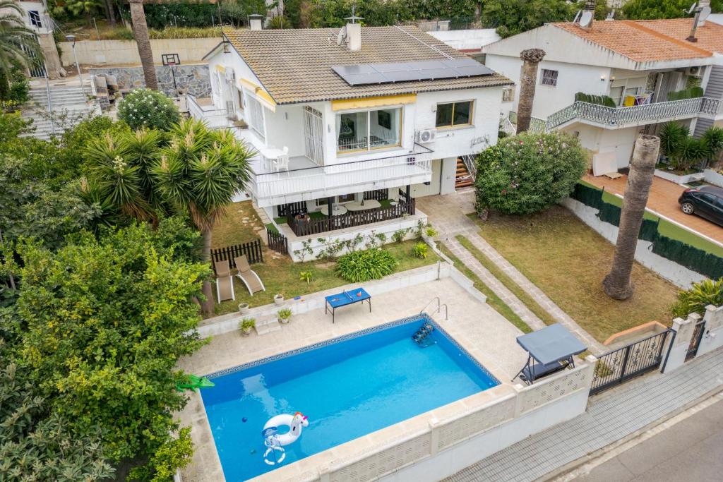 an aerial view of a house with a swimming pool at Oasis Salou Pool Beach and Bbq in Salou
