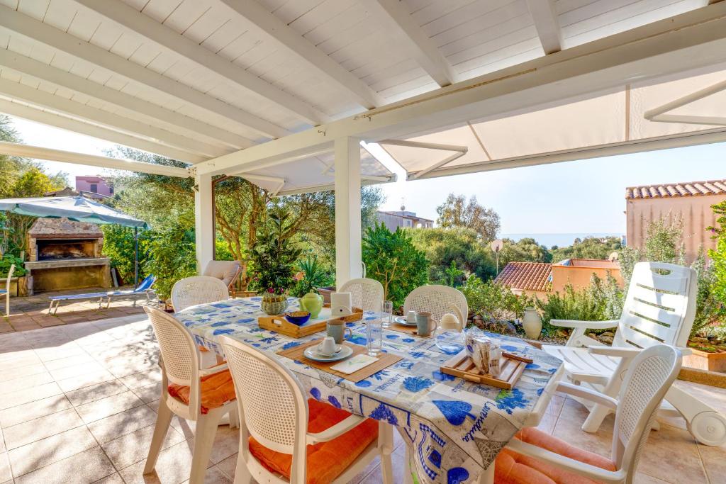 a dining room with a table and chairs on a patio at Casa Donatella Torre dei Corsari in Torre Dei Corsari
