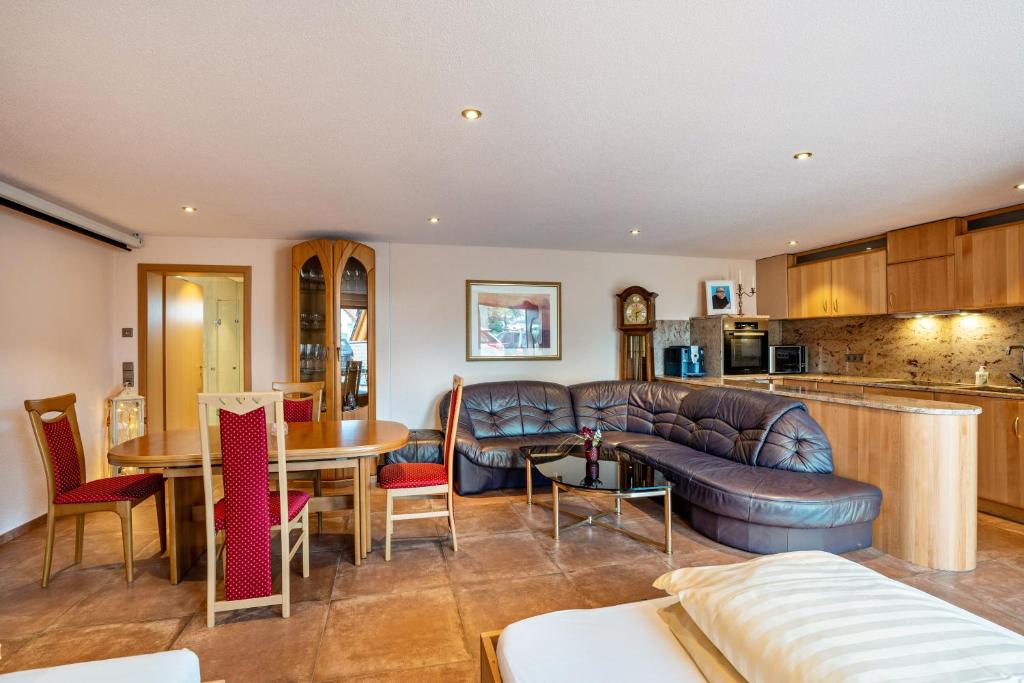 a living room with a couch and a table at Haus am Bächel 2 in Obersasbach
