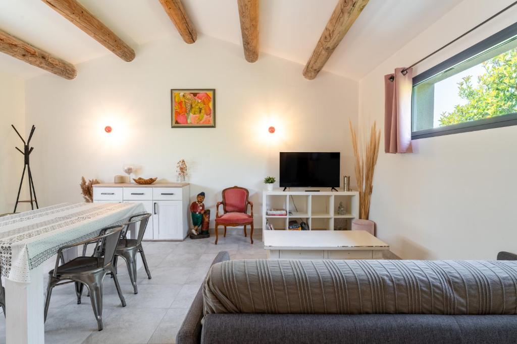 a living room with a couch and a table at Bergeries Saumane, Les Lavandes in Saumane-de-Vaucluse