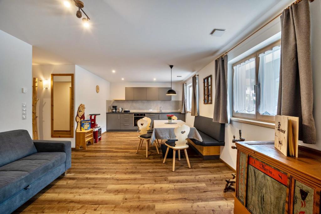 a living room with a couch and a table at Krämerhof Apt Peitlerkofel in Rodengo