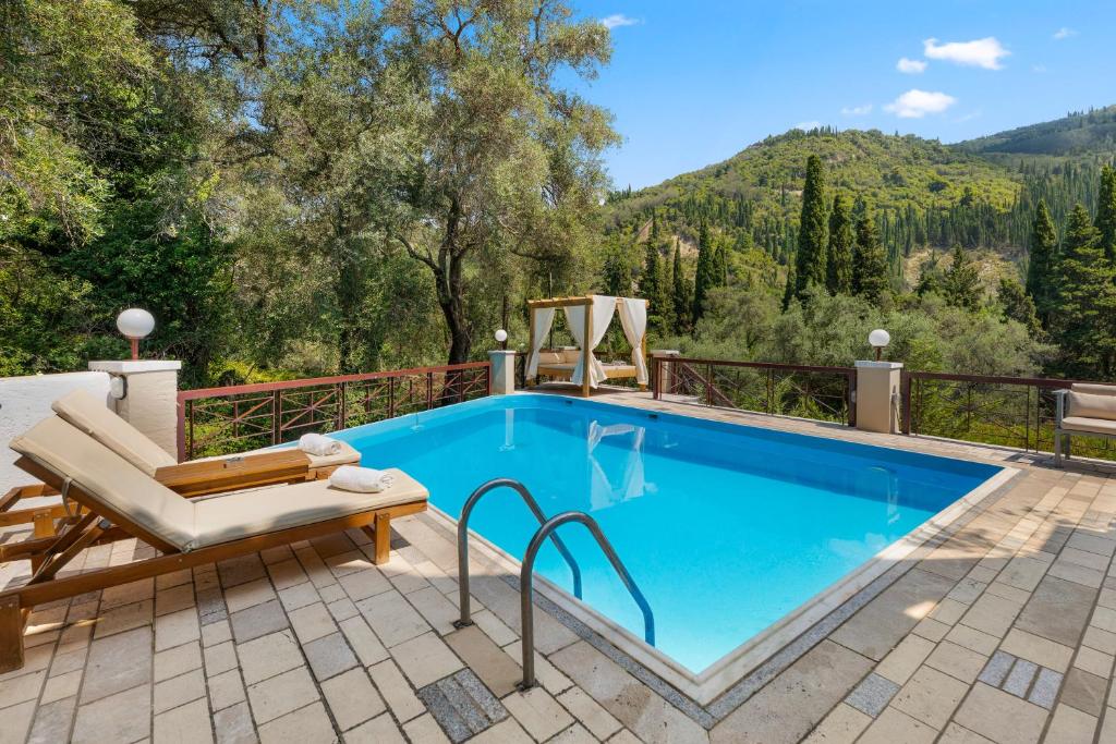 a pool on a patio with a chair and a chair at Doliva Studio with private pool in Agios Gordios