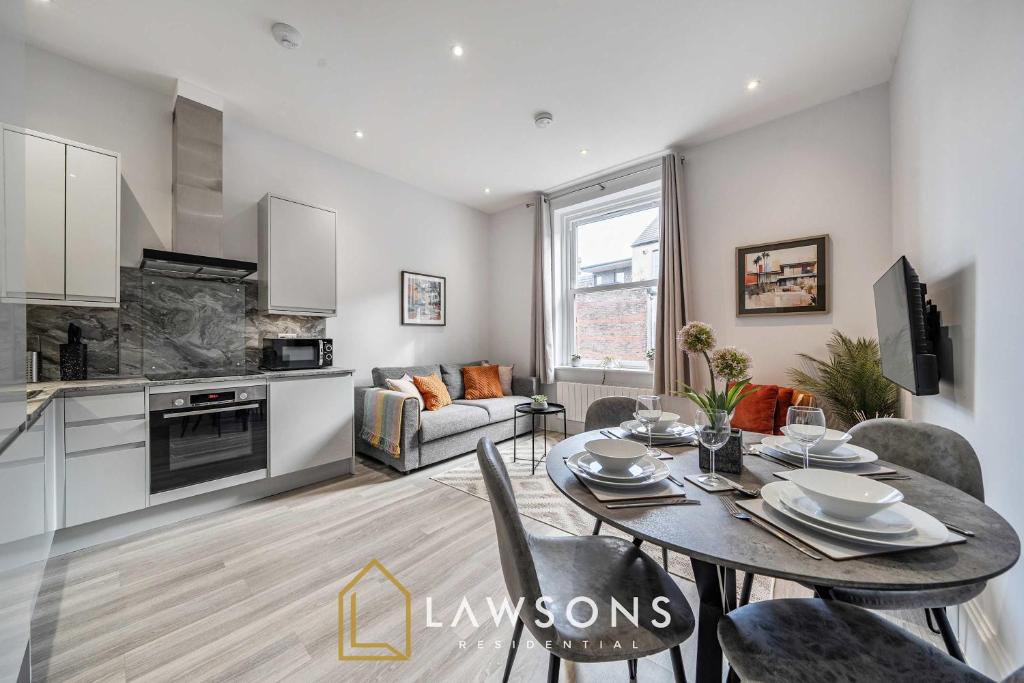 a kitchen and living room with a table and chairs at Sea You Soon I Seafront Stay in Portsmouth