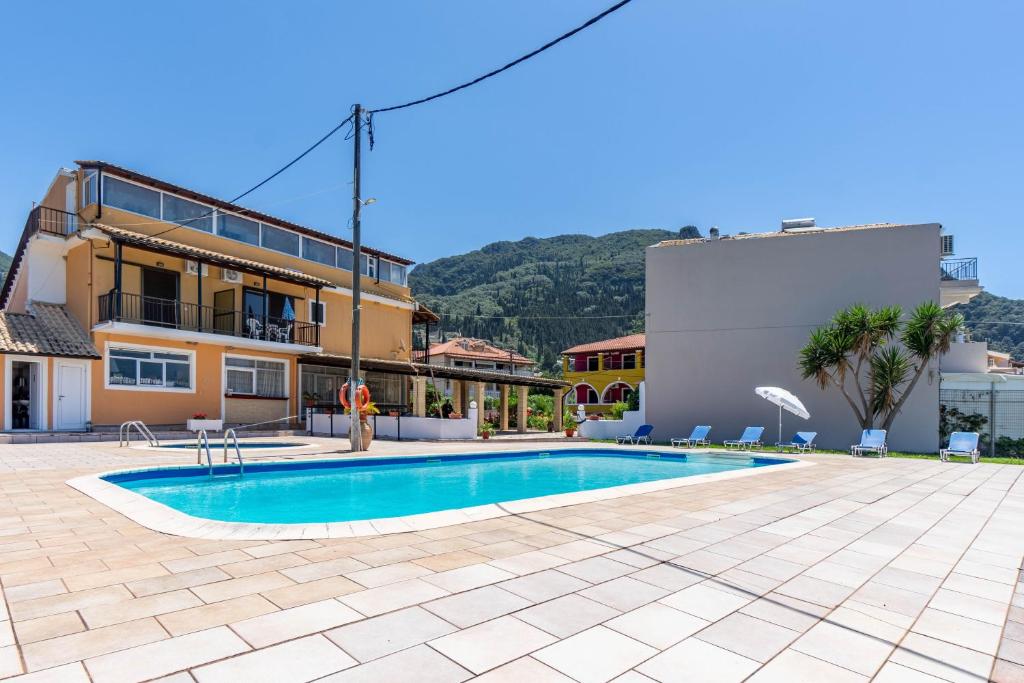 a swimming pool in front of a building at Mires House Side First Floor 9 in Agios Gordios