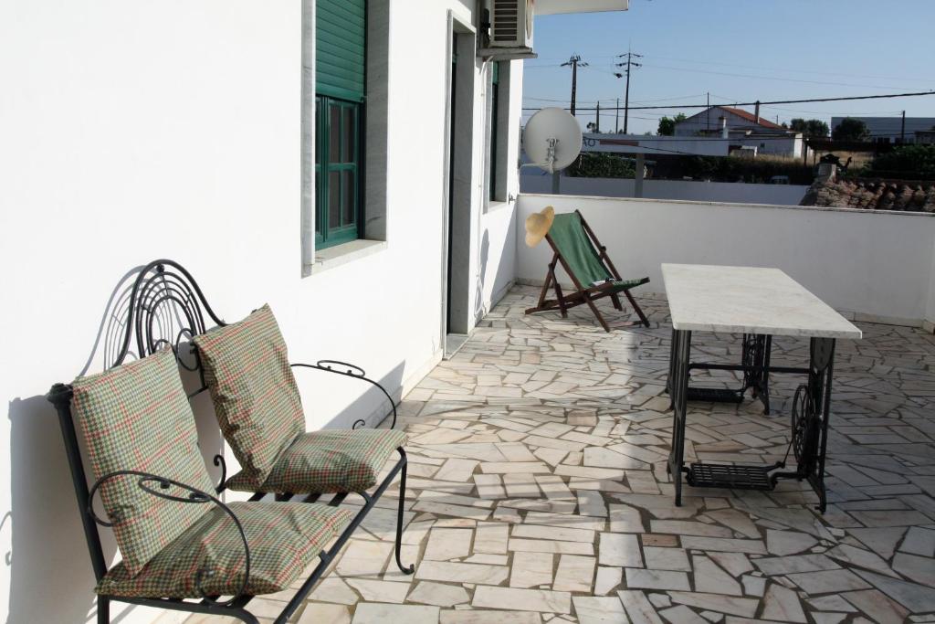 a patio with two chairs and a table on a building at Casa do Sossego in Safara