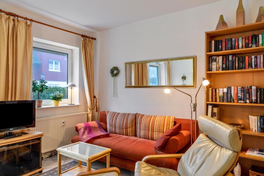 a living room with a couch and a tv at Ferienwohnung Tannenblick 3-1 in Oberhof