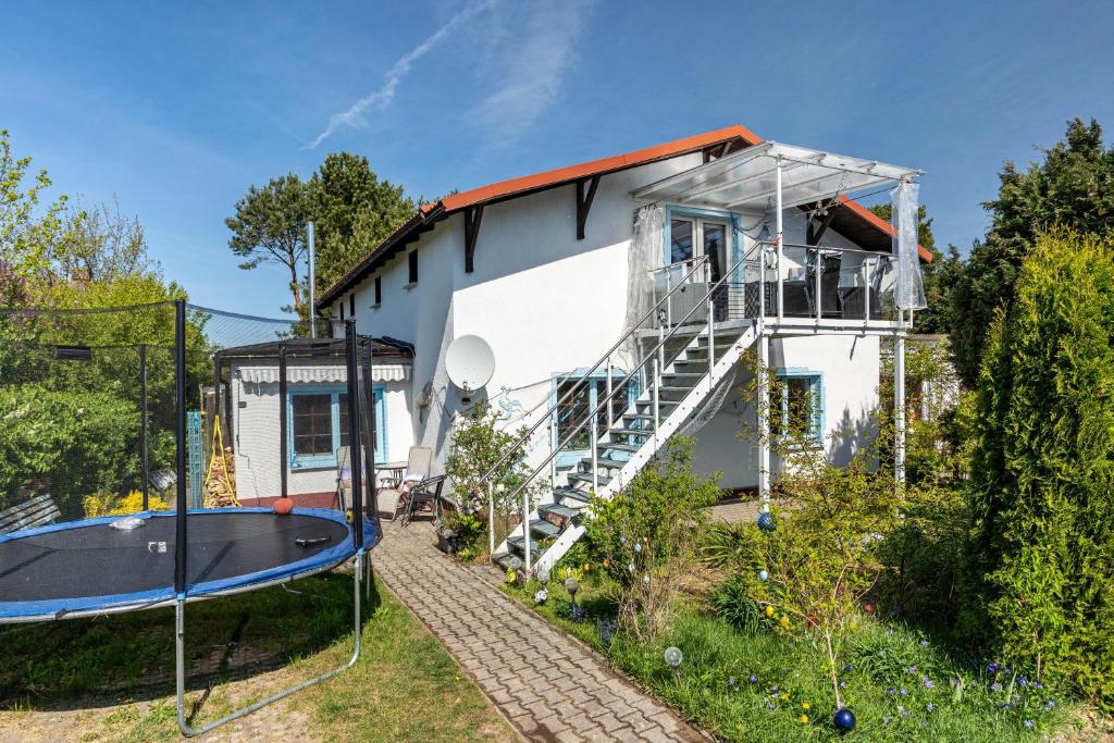 a house with a trampoline in the yard at Ostseeblick in Kröslin