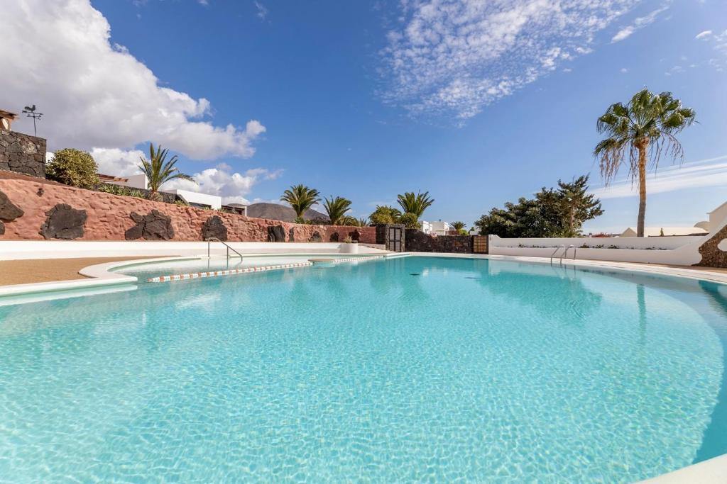 a large swimming pool with blue water at Villasal in Playa Blanca