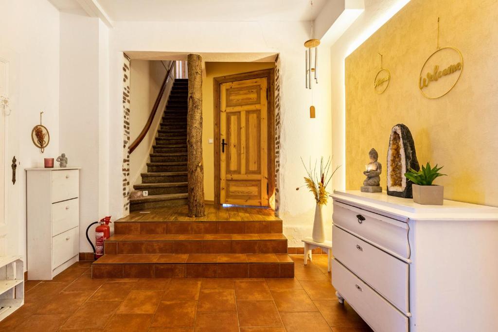 a hallway with stairs and a wooden door at Haevn Erholung,Wattenmeer &Wäldchen in Reußenköge