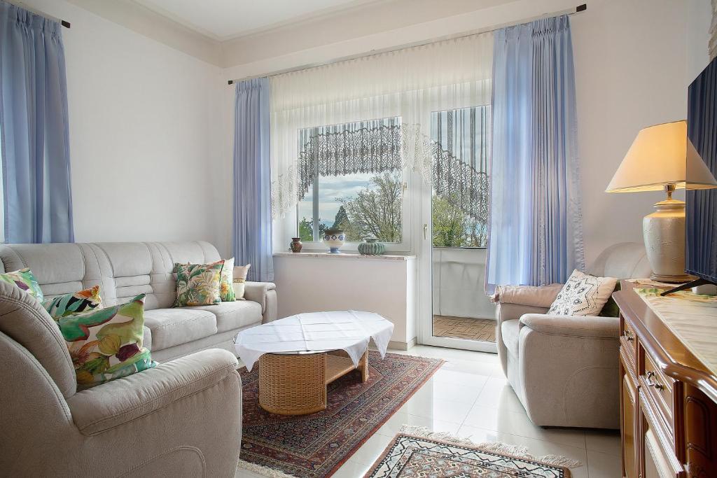 a living room with two couches and a table at Thaicenter Bodensee 2 in Friedrichshafen