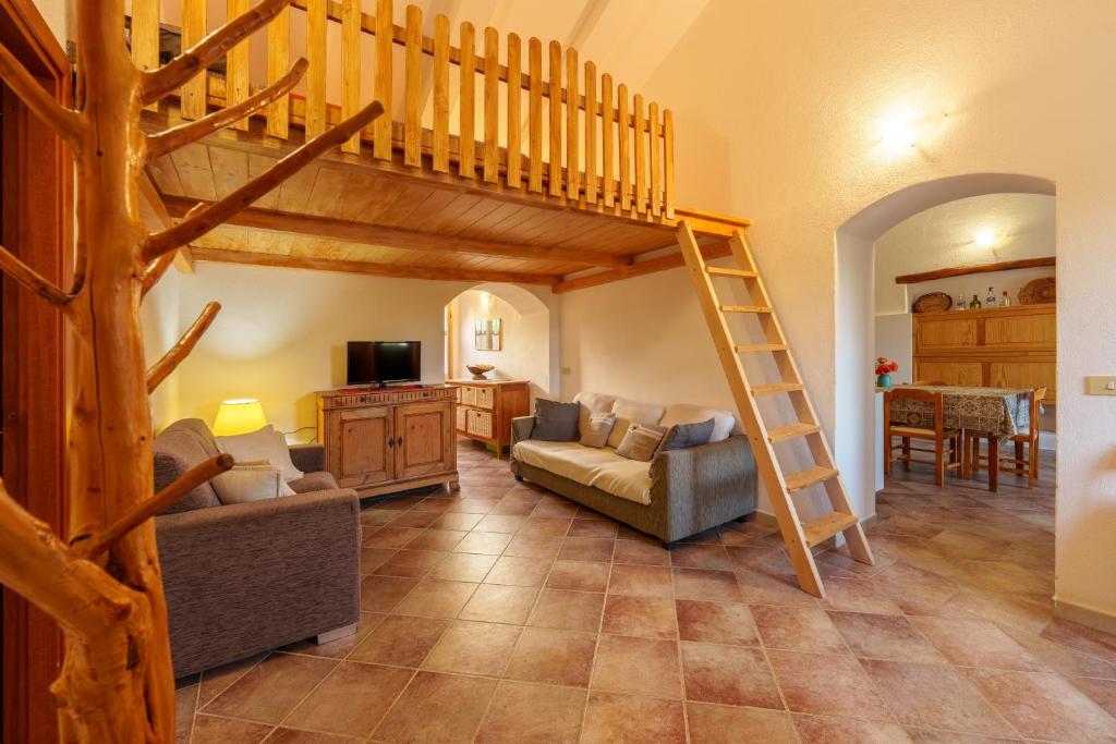 a living room with a loft bed and a couch at Casa vacanza Macciunitta in Arzachena