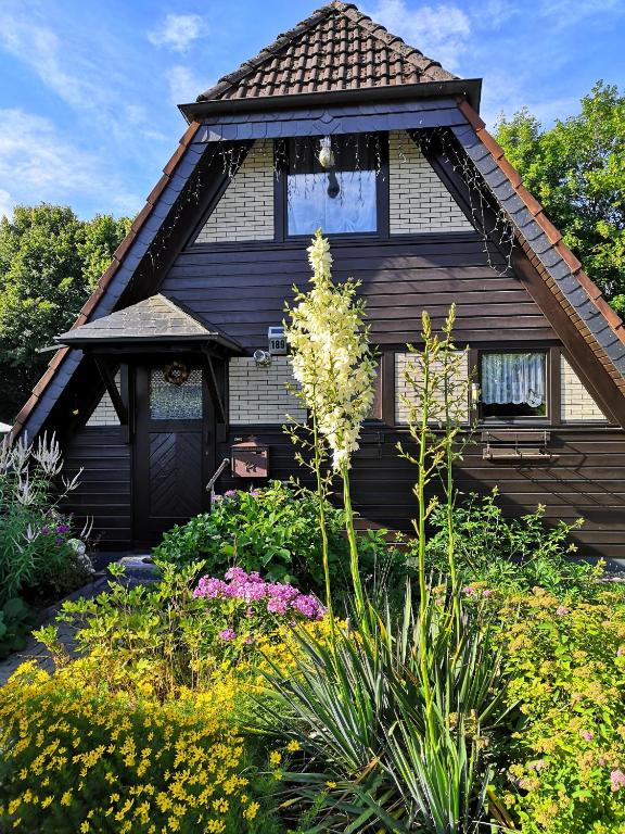 a house with a garden of flowers in front of it at Haus Paradiesecke in Waldbrunn
