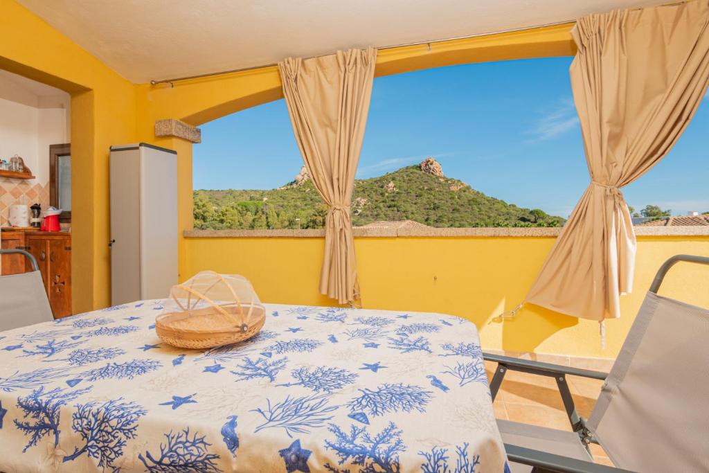 a room with a table and a view of a mountain at Seahouserent in Cannigione