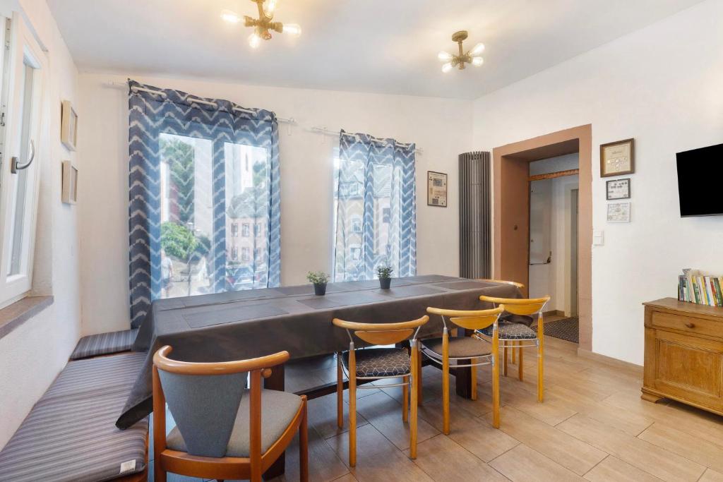 a dining room with a large table and chairs at Ferienhaus alte Münze in Neuerburg