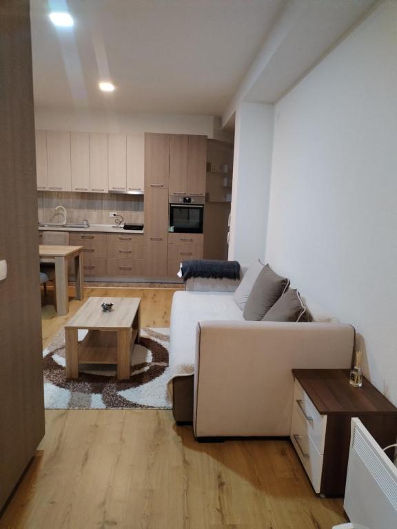 a living room with a couch and a table at Stan na dan in Svilajnac