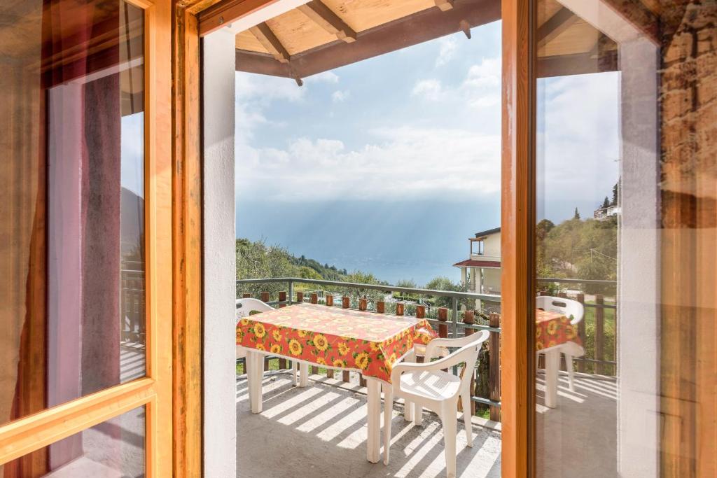 a view of a balcony with a table and chairs at App Olivo Casa Demonti in Tignale