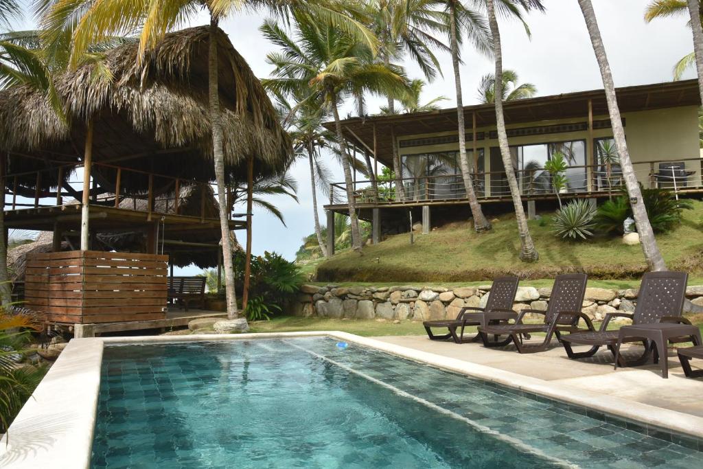 a villa with a swimming pool and a resort at Casa AltoMar in Palomino