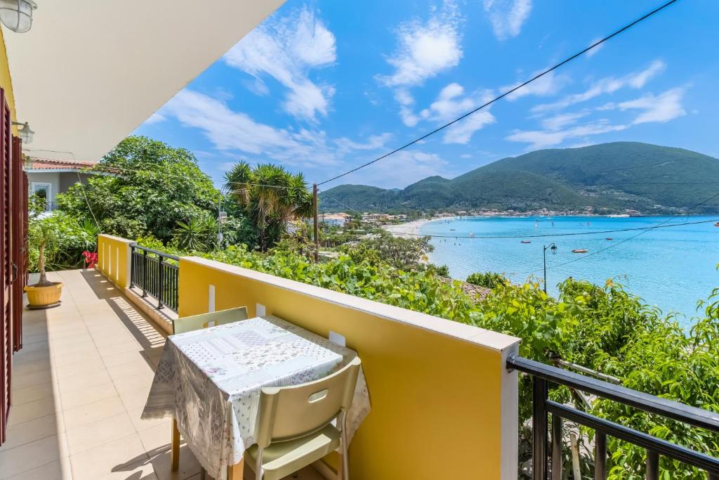a balcony with a table and chairs overlooking the ocean at Villa Captain Fotis 2 in Póndi