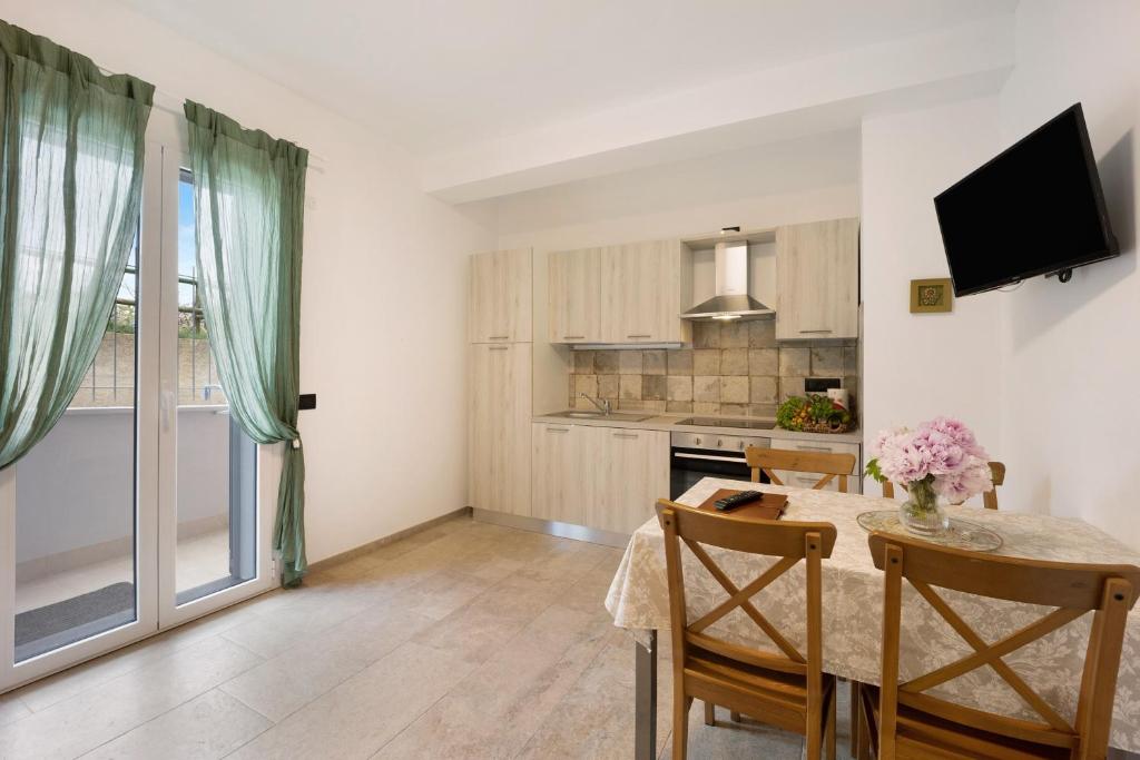a kitchen and a dining room with a table and a dining room at Antichi Ricordi - La Stalla in Marina di Andora
