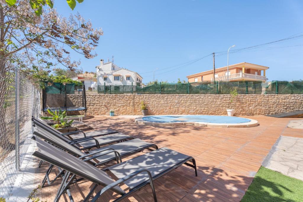 a group of chairs on a patio with a pool at Castellana in Bicorp
