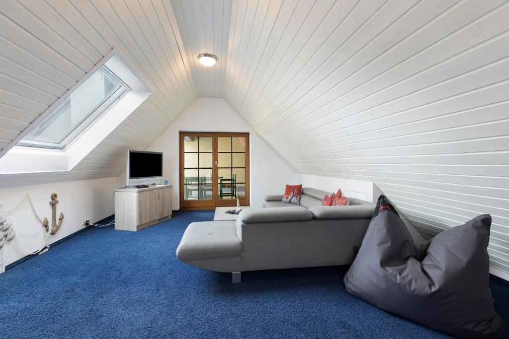 a living room with a couch and a window at Untersee Appartements in Moos