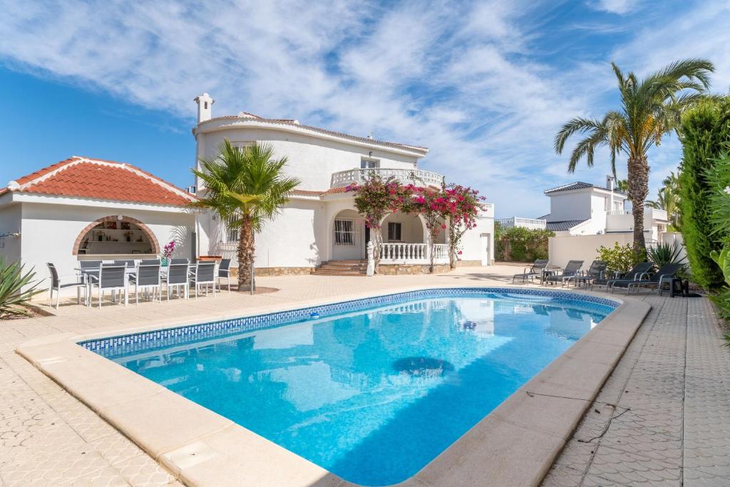 a swimming pool in front of a villa at Modern villa with great location in Ciudad Quesada