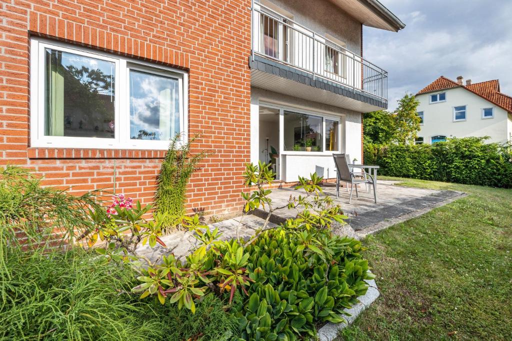 a brick house with a window and a patio at Ferienwohnung Deister Blick in Rodenberg