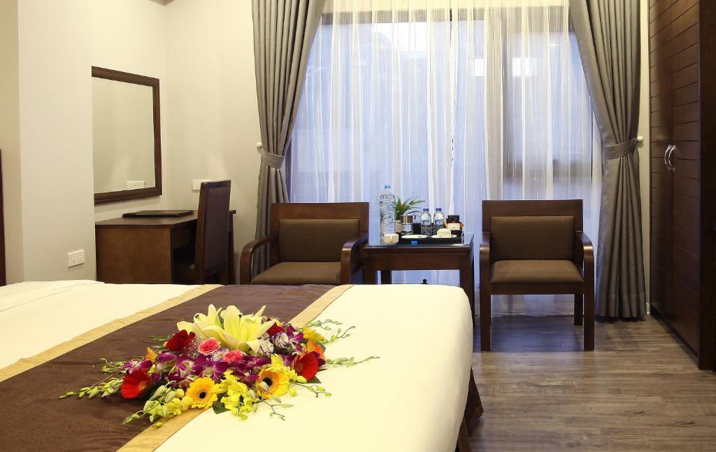 Postel nebo postele na pokoji v ubytování Blue Pearl West Hotel