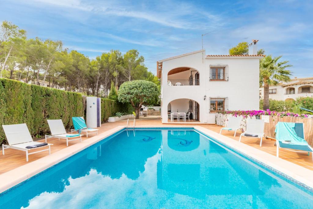 a villa with a swimming pool and a house at La Boniquesa in Benissa