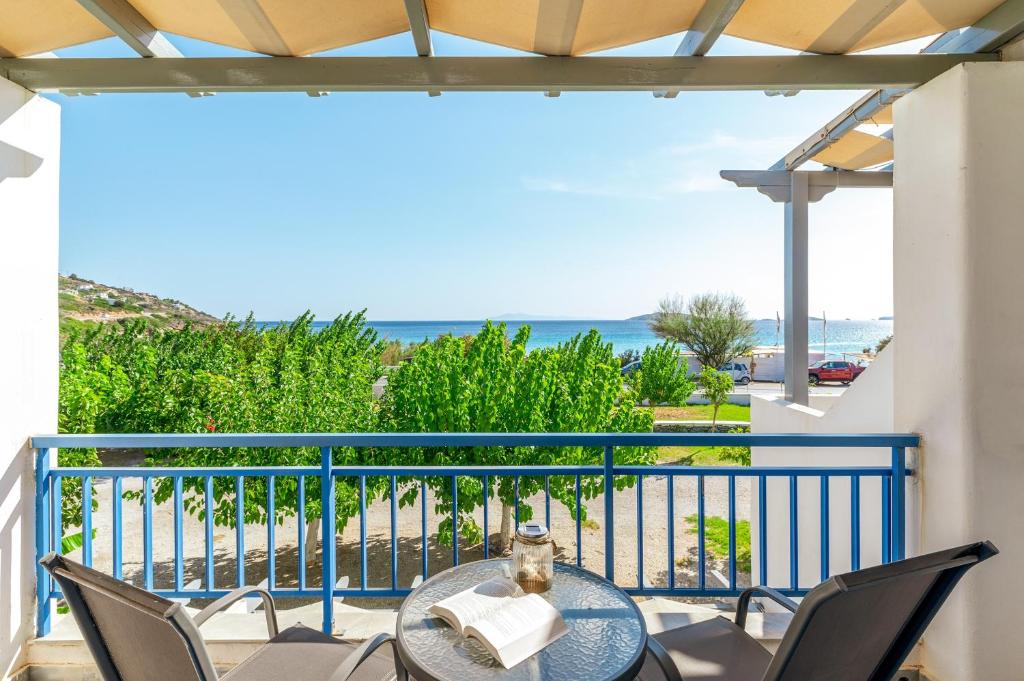 a balcony with a table and chairs and the ocean at Perasma Studio 3 in Kipri